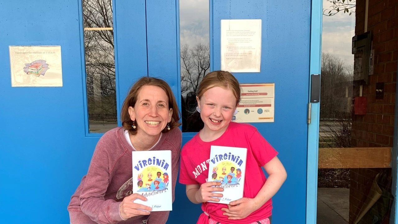Tara Fisher smiles with a young reader of